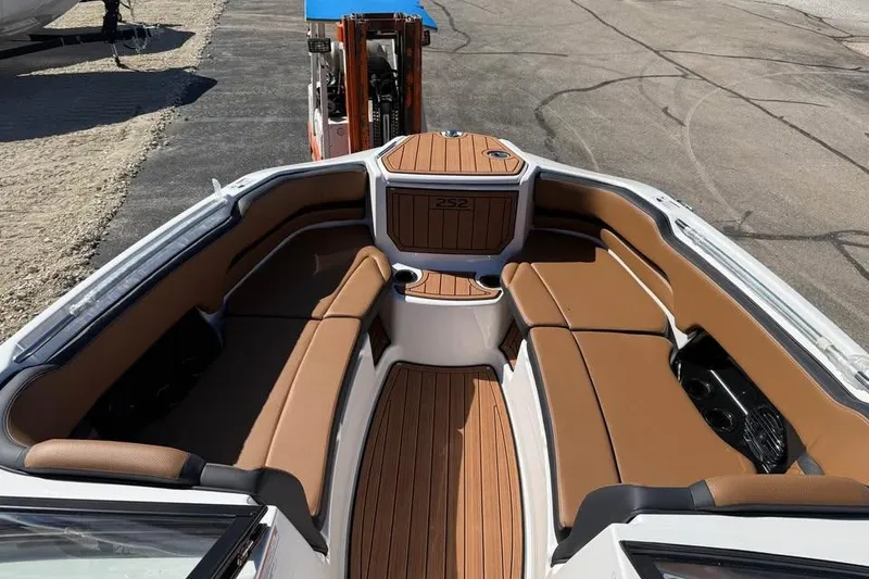 Slide: The Image of 2026 Yamaha Boats 252SD interior with brown seating and wood accents. - 12