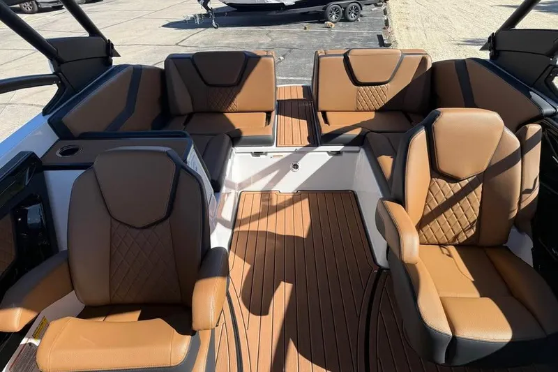 Slide: The Image of 2026 Yamaha Boats 252SD interior with luxurious brown seating and sleek design. - 13