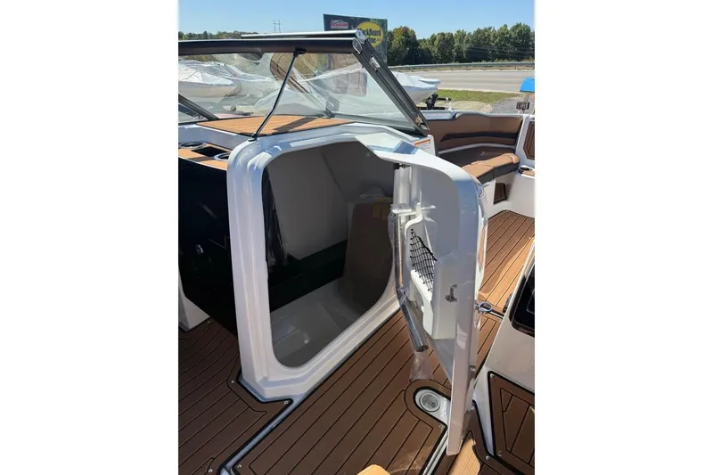 Slide: The Image of 2026 Yamaha Boats 252SD interior with open storage compartment and sleek wooden flooring. - 15