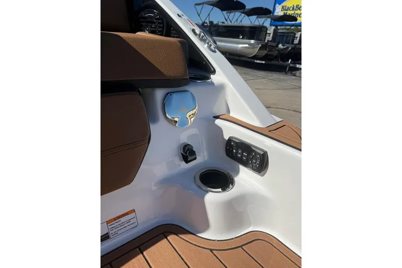 Slide: The Image of 2026 Yamaha Boats 252SD interior detail with control panel and cup holder. - 17