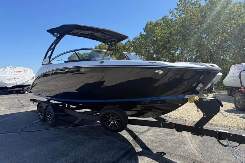 Slide: The Image of 2026 Yamaha Boats 252SD on trailer, sleek black design, parked outdoors. - 3