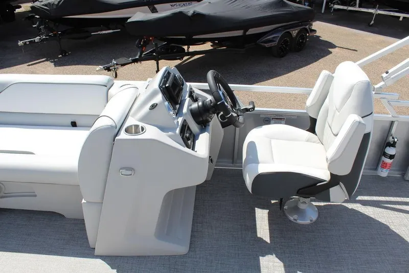 Slide: The Image of 2025 Avalon Venture 85 Versatile Rear Bench boat interior with steering console and seating. - 22