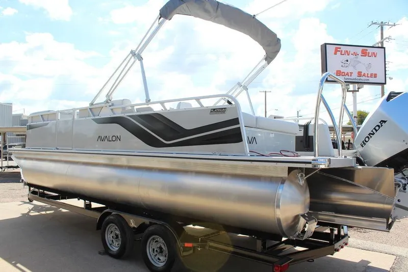 Slide: The Image of 2025 Avalon Venture 85 Versatile Rear Bench pontoon boat at dealership, featuring sleek design. - 5