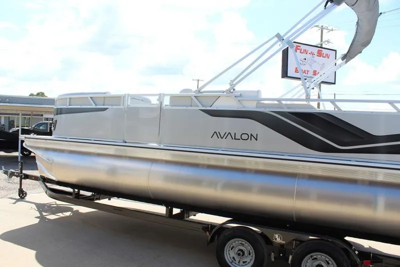 Slide: The Image of 2025 Avalon Venture 85 Versatile Rear Bench pontoon boat on trailer, side view. - 6