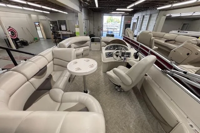 Slide: The Image of Interior of a 2009 South Bay 722 FCR pontoon boat with plush seating and steering console. - 10