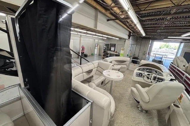 Slide: The Image of Interior of 2009 South Bay 722 FCR pontoon boat with plush seating and steering console. - 11