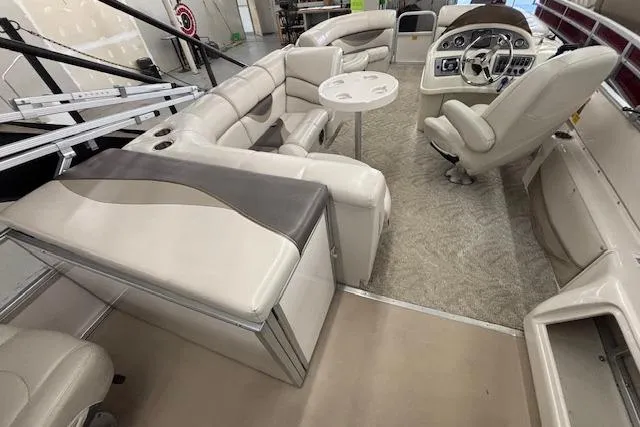 Slide: The Image of Interior of 2009 South Bay 722 FCR boat with plush seating and steering console. - 12