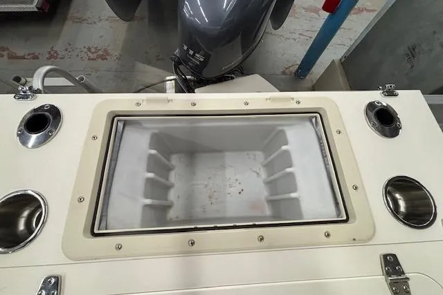 Slide: The Image of 2009 South Bay 722 FCR boat with built-in storage compartment and motor. - 13