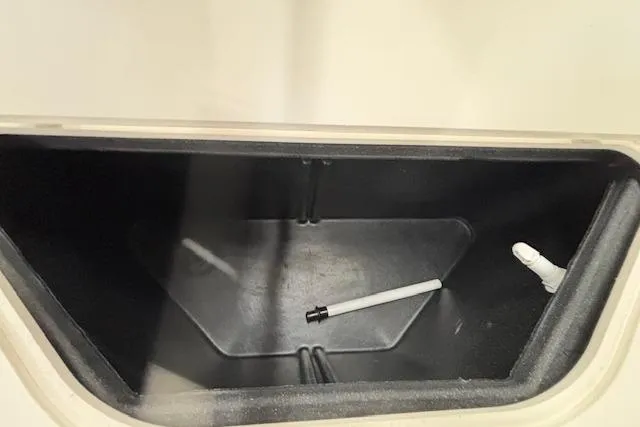 Slide: The Image of Storage compartment of a 2009 South Bay 722 FCR boat, featuring a black interior. - 14