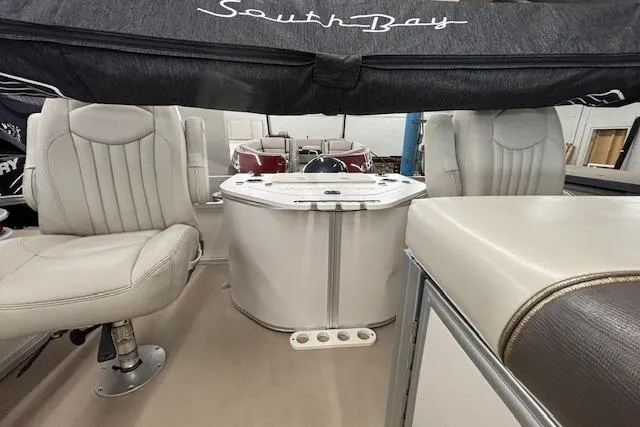 Slide: The Image of Interior of 2009 South Bay 722 FCR boat with seating and table. - 17