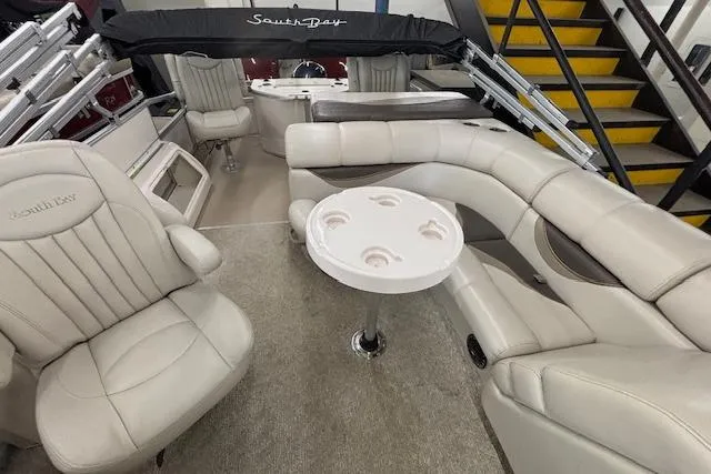 Slide: The Image of Luxurious interior of a 2009 South Bay 722 FCR pontoon boat with plush seating and table. - 20