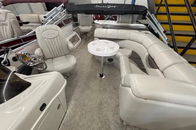 Slide: The Image of Luxurious 2009 South Bay 722 FCR boat interior with plush seating and steering console. - 21