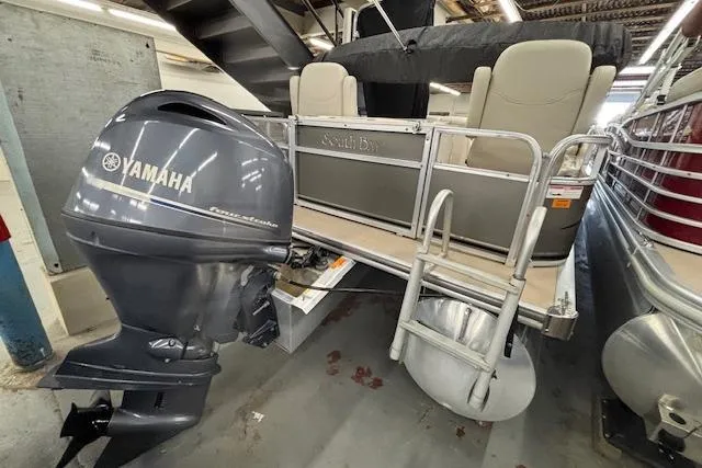 Slide: The Image of 2009 South Bay 722 FCR pontoon boat with Yamaha outboard motor in a storage facility. - 3