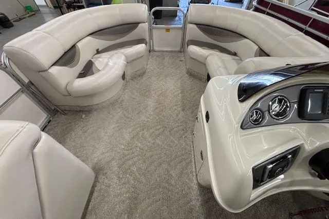 Slide: The Image of 2009 South Bay 722 FCR boat interior with plush seating and modern dashboard. - 4