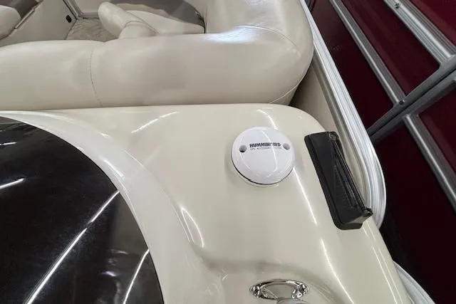 Slide: The Image of 2009 South Bay 722 FCR boat interior with beige seating and a mounted device. - 5