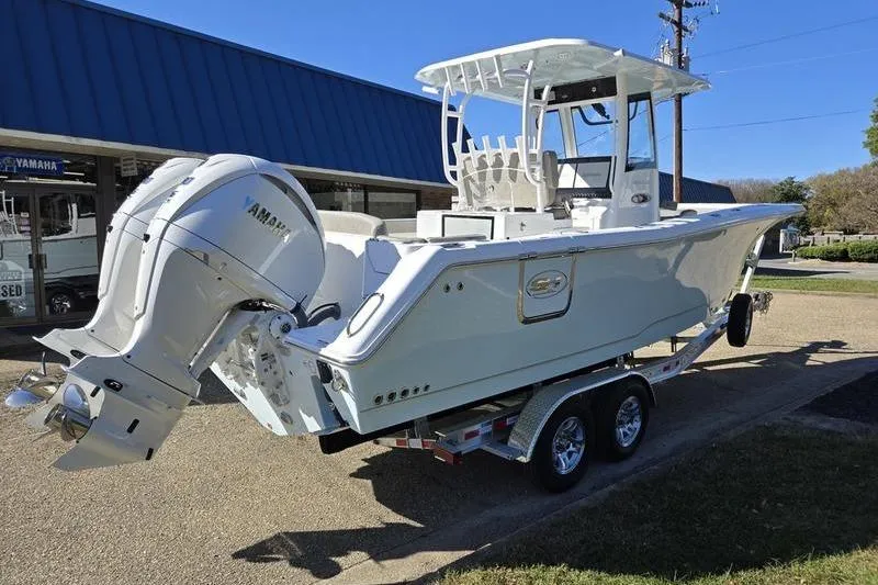 Slide: The Image of 2026 Sea Hunt Ultra 285 SE boat on trailer, featuring Yamaha outboard motor. - 10