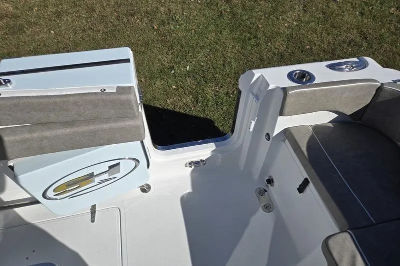 Slide: The Image of 2026 Sea Hunt Ultra 285 SE boat interior with seating and cup holders. - 12