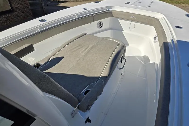 Slide: The Image of 2026 Sea Hunt Ultra 285 SE boat interior with cushioned seating and speakers. - 15