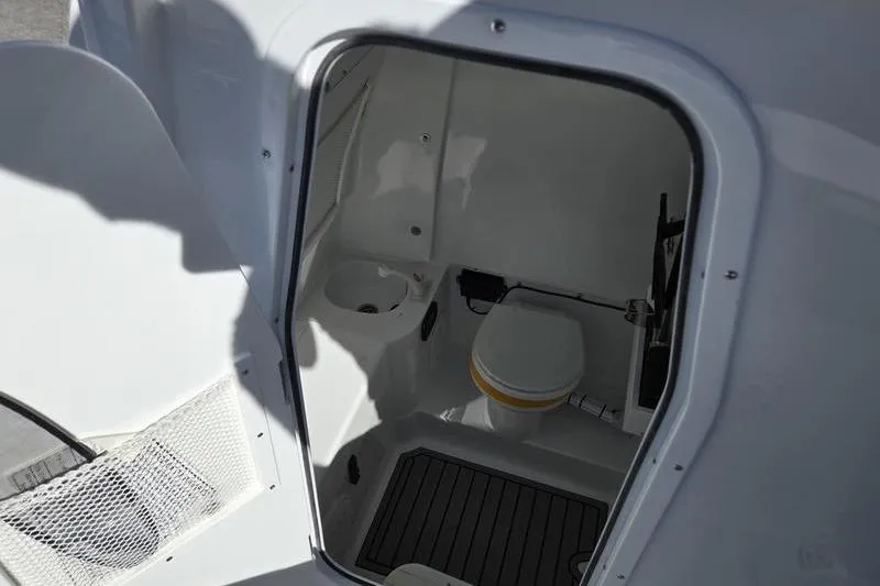 Slide: The Image of Interior view of 2026 Sea Hunt Ultra 285 SE boat bathroom with toilet and sink. - 17