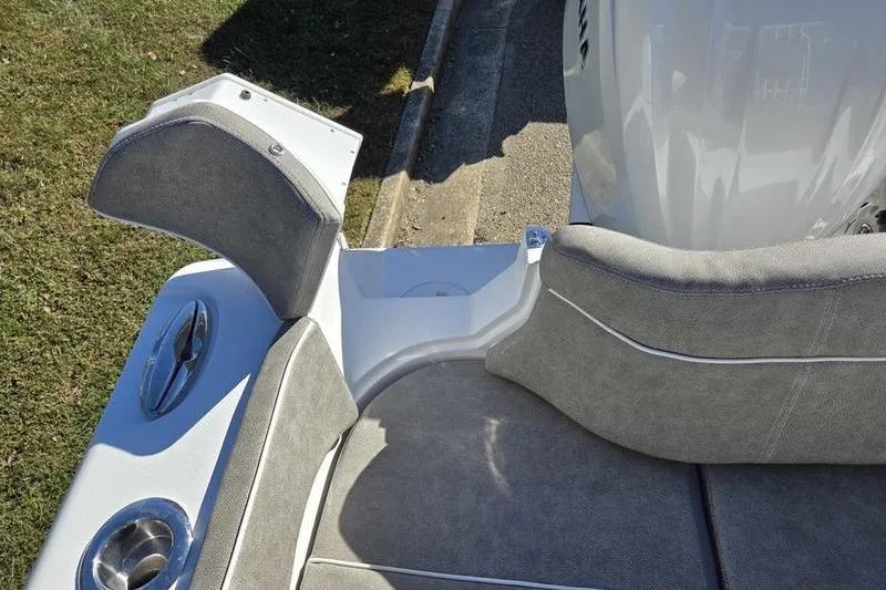 Slide: The Image of 2026 Sea Hunt Ultra 285 SE boat seating area with cup holders and gray upholstery. - 29