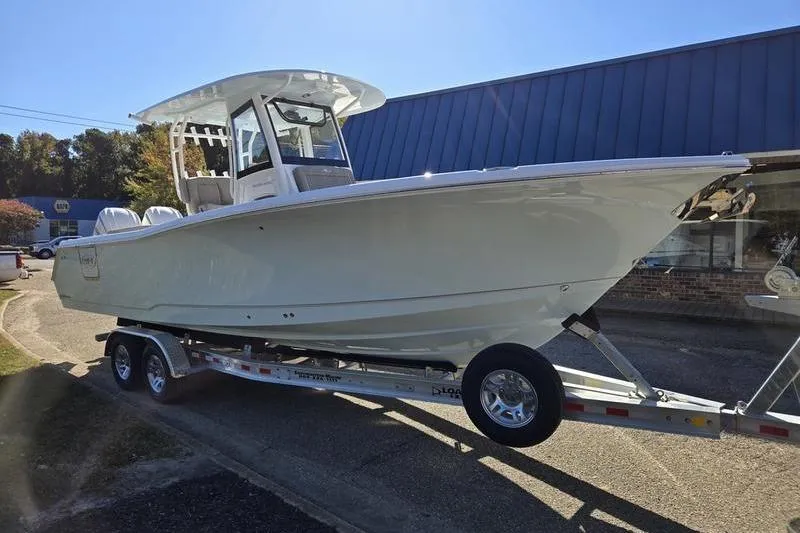 Slide: The Image of 2026 Sea Hunt Ultra 285 SE boat on trailer, parked outdoors. - 31