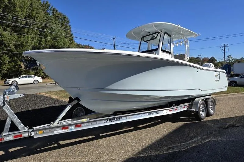 Slide: The Image of 2026 Sea Hunt Ultra 285 SE boat on trailer, parked outdoors. - 32