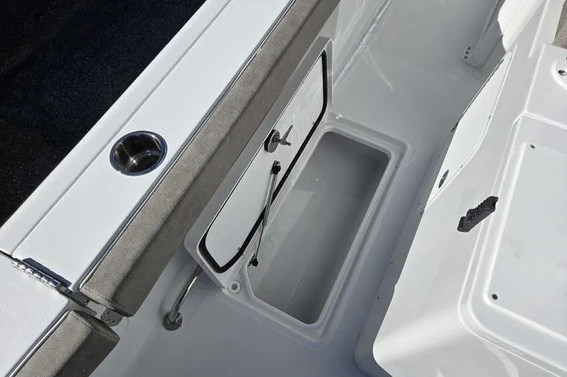Slide: The Image of 2026 Sea Hunt Ultra 285 SE boat storage compartment with cup holder and cushioned seating. - 6