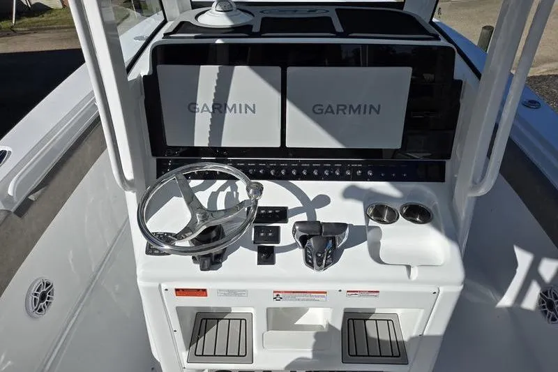 Slide: The Image of 2026 Sea Hunt Ultra 285 SE boat dashboard with Garmin displays and steering wheel. - 9