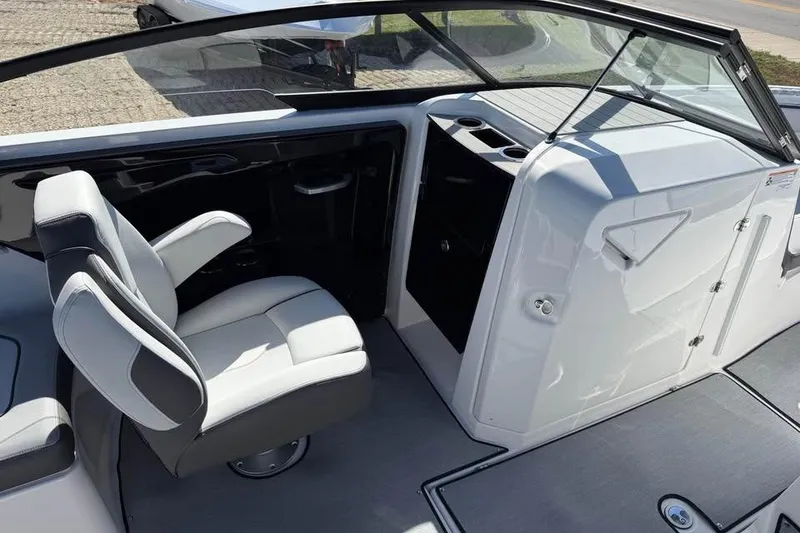 Slide: The Image of Interior view of 2026 Yamaha Boats AR250, featuring a sleek captain's chair and modern dashboard. - 10