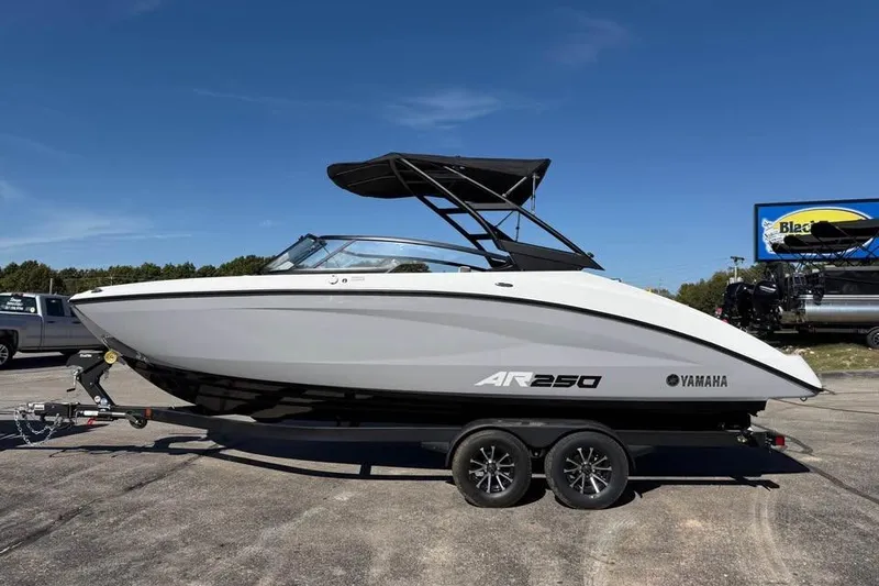 Slide: The Image of 2026 Yamaha Boats AR250 on trailer under clear blue sky. - 4