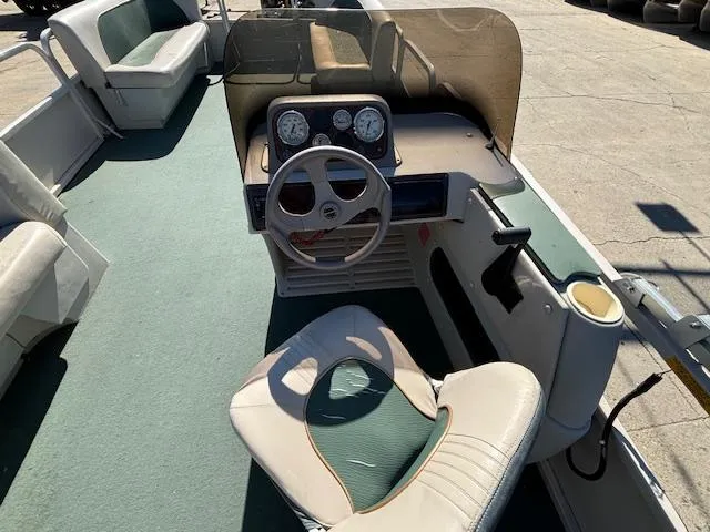 Slide: The Image of 1999 Crestliner 2480 SPORT LX boat interior with steering wheel and seating. - 10