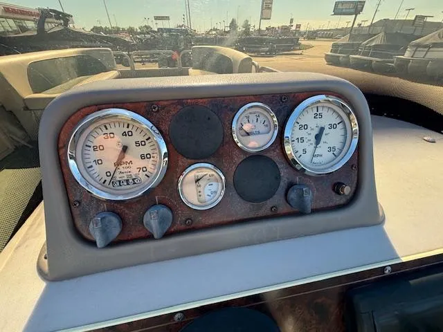 Slide: The Image of Dashboard of a 1999 Crestliner 2480 SPORT LX boat with gauges and controls. - 11