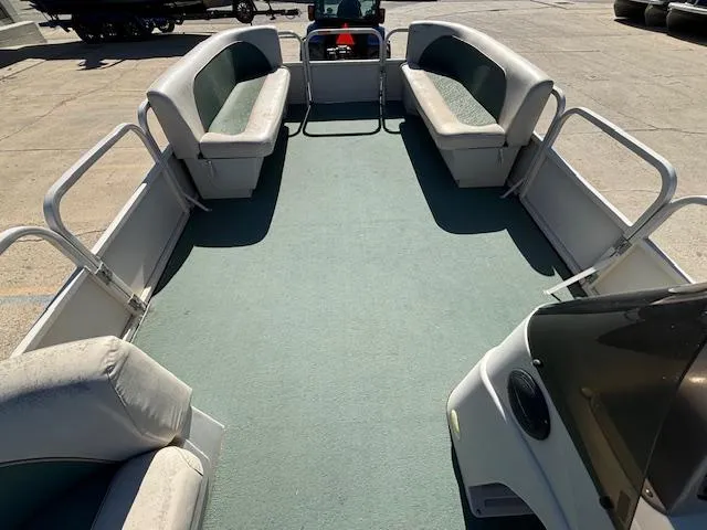Slide: The Image of 1999 Crestliner 2480 SPORT LX pontoon boat interior with spacious seating and open deck. - 13