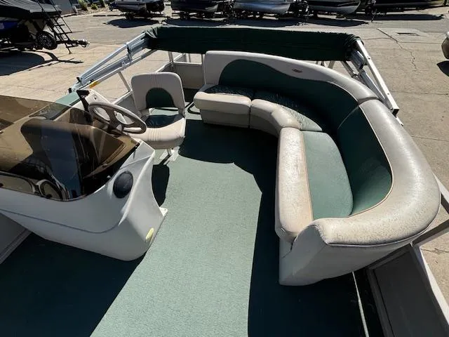 Slide: The Image of 1999 Crestliner 2480 SPORT LX boat interior with seating and steering console. - 18