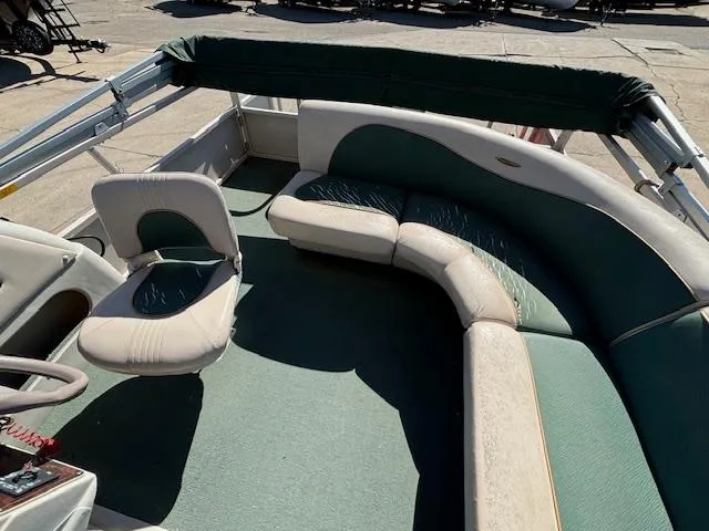 Slide: The Image of 1999 Crestliner 2480 SPORT LX boat interior with green and beige seating. - 19