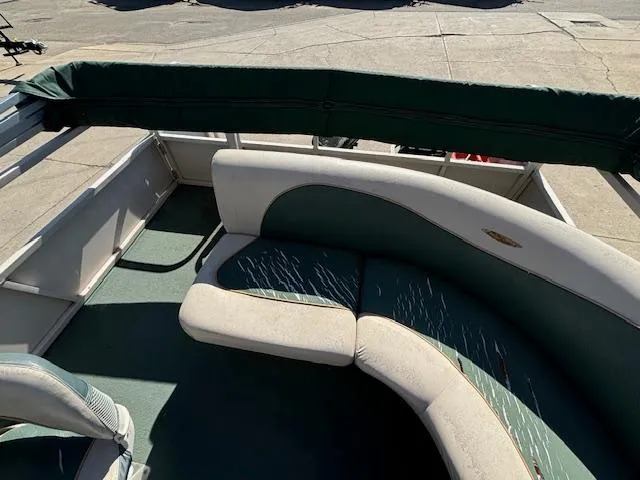 Slide: The Image of 1999 Crestliner 2480 SPORT LX boat interior with green and beige seating. - 20