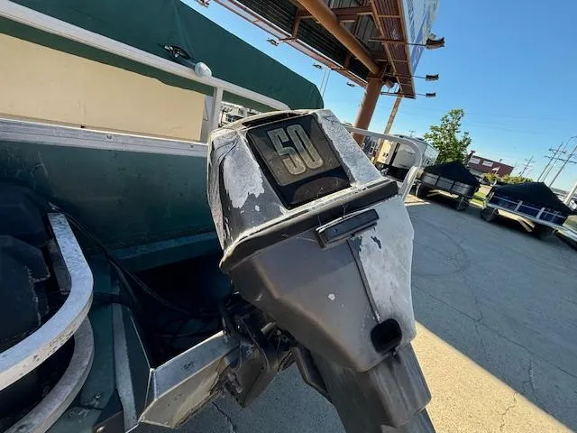 Slide: The Image of 1999 Crestliner 2480 SPORT LX boat with a 50 HP outboard motor in a parking lot. - 4