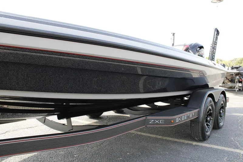Slide: The Image of 2026 Skeeter ZXE21 boat on trailer, sleek design, black and white finish. - 11