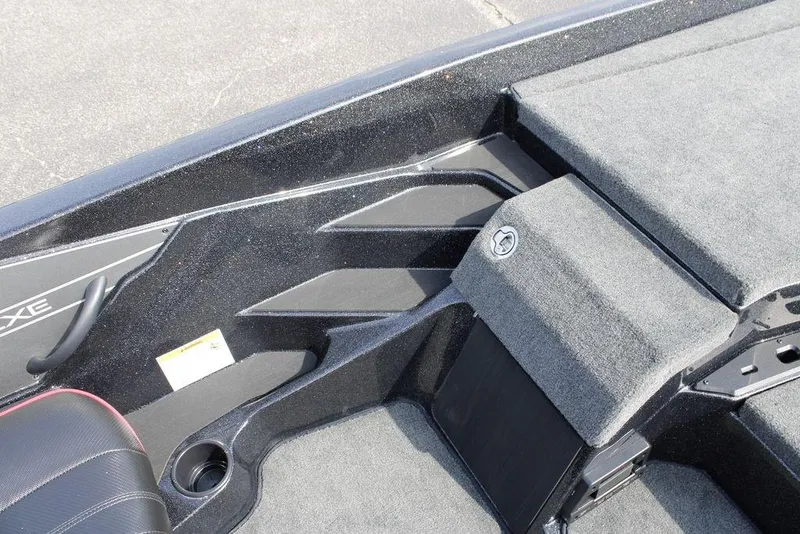 Slide: The Image of 2026 Skeeter ZXE21 boat interior with gray carpet and storage compartments. - 12