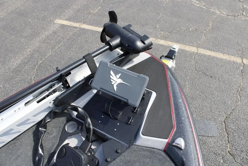 Slide: The Image of 2026 Skeeter ZXE21 boat dashboard with steering wheel and mounted device. - 14