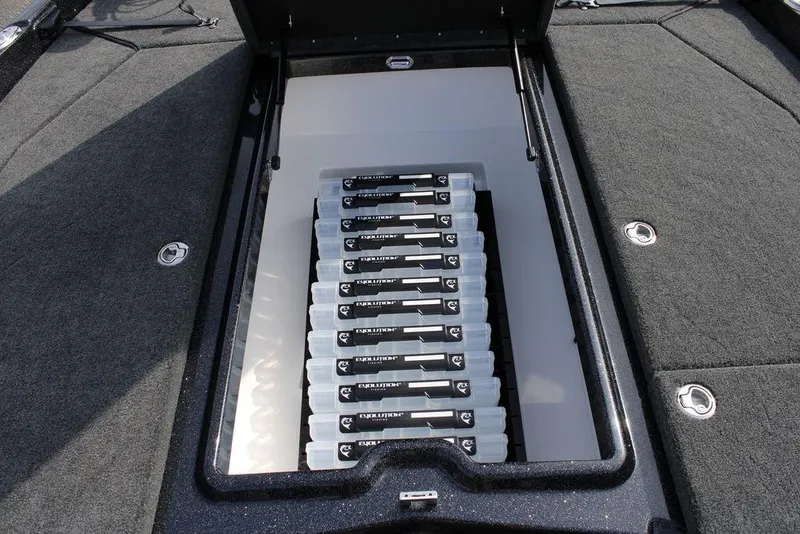 Slide: The Image of Storage compartment of 2026 Skeeter ZXE21 boat with organized tackle boxes. - 17