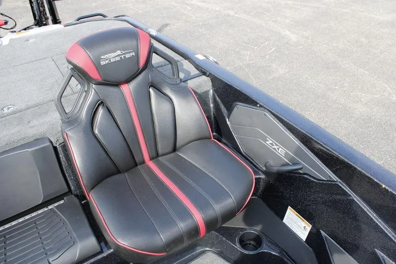 Slide: The Image of 2026 Skeeter ZXE21 boat seat with black and red design, showcasing sleek interior. - 19