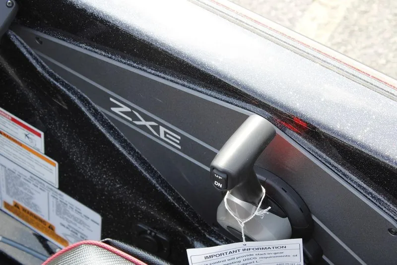 Slide: The Image of 2026 Skeeter ZXE21 boat interior with control lever and safety labels. - 20