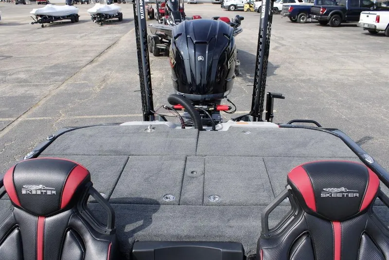 Slide: The Image of 2026 Skeeter ZXE21 boat with dual seats and powerful outboard motor in a parking lot. - 30