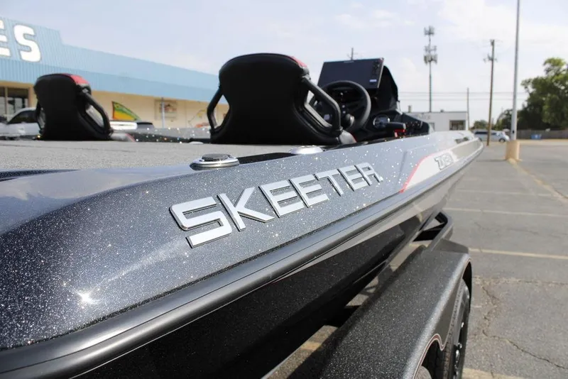 Slide: The Image of 2026 Skeeter ZXE21 boat with sleek design and metallic finish in parking lot. - 8