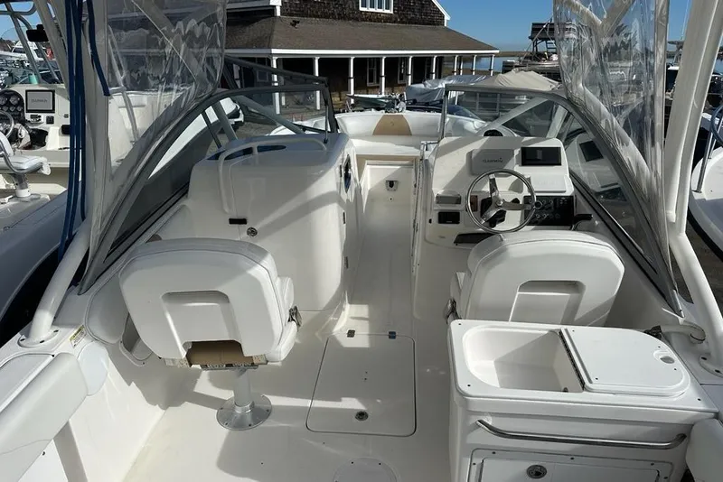 Slide: The Image of 2014 Edgewater 245CX Crossover boat interior with seating and steering console. - 14