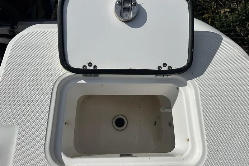 Slide: The Image of Open storage compartment on 2014 Edgewater 245CX Crossover boat. - 17