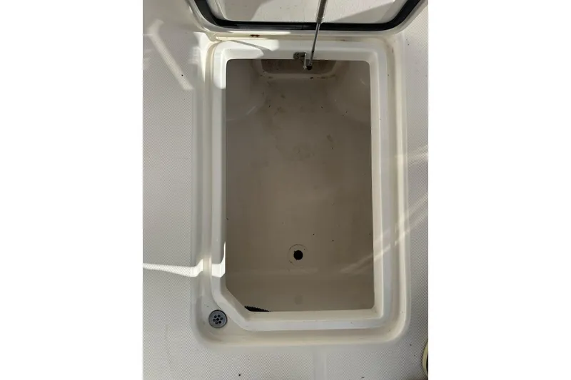 Slide: The Image of Open storage compartment on 2014 Edgewater 245CX Crossover boat. - 18