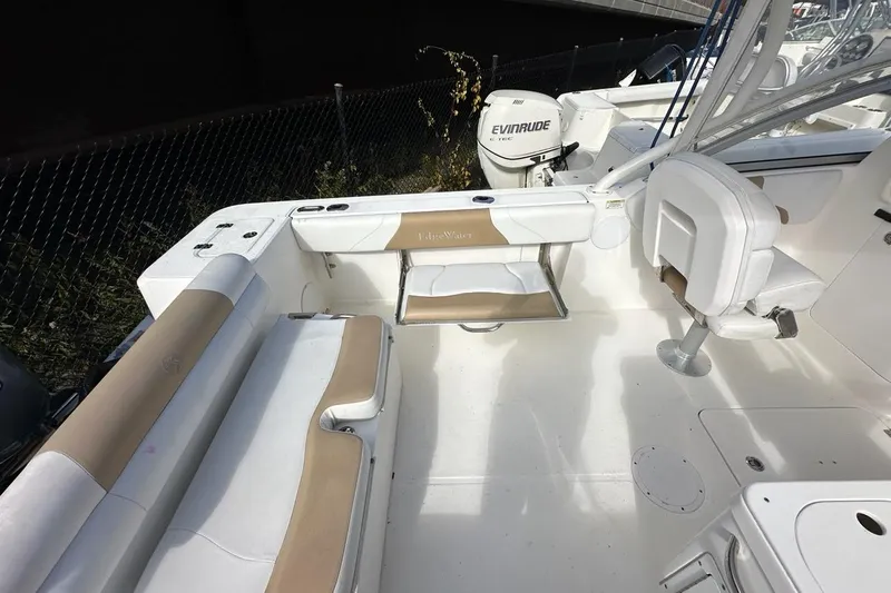 Slide: The Image of 2014 Edgewater 245CX Crossover boat interior with seating and Evinrude engine. - 21
