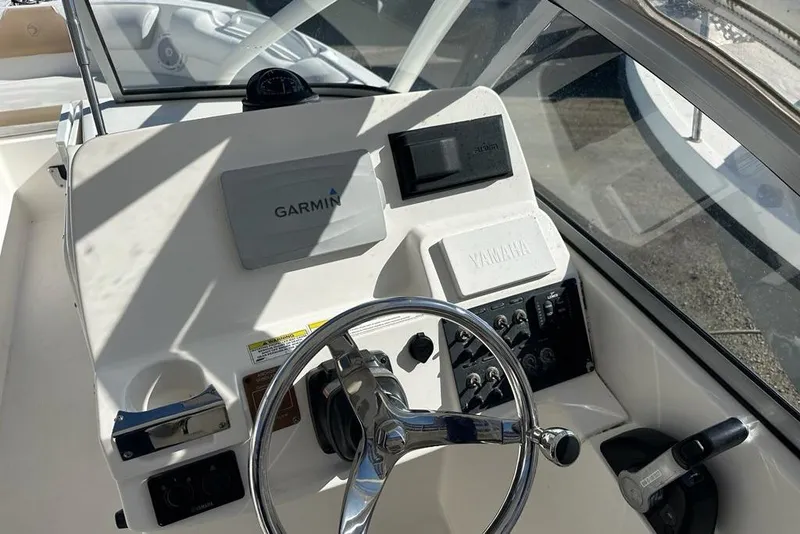 Slide: The Image of 2014 Edgewater 245CX Crossover boat dashboard with Garmin navigation and Yamaha controls. - 3